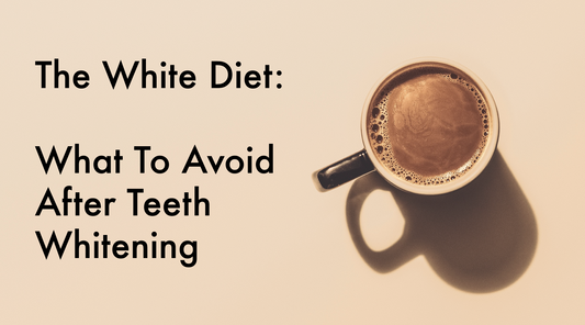 Overhead view of a full cup of coffee on a beige backdrop with black overlay text reading "The White Diet - What to Avoid After Teeth Whitening"