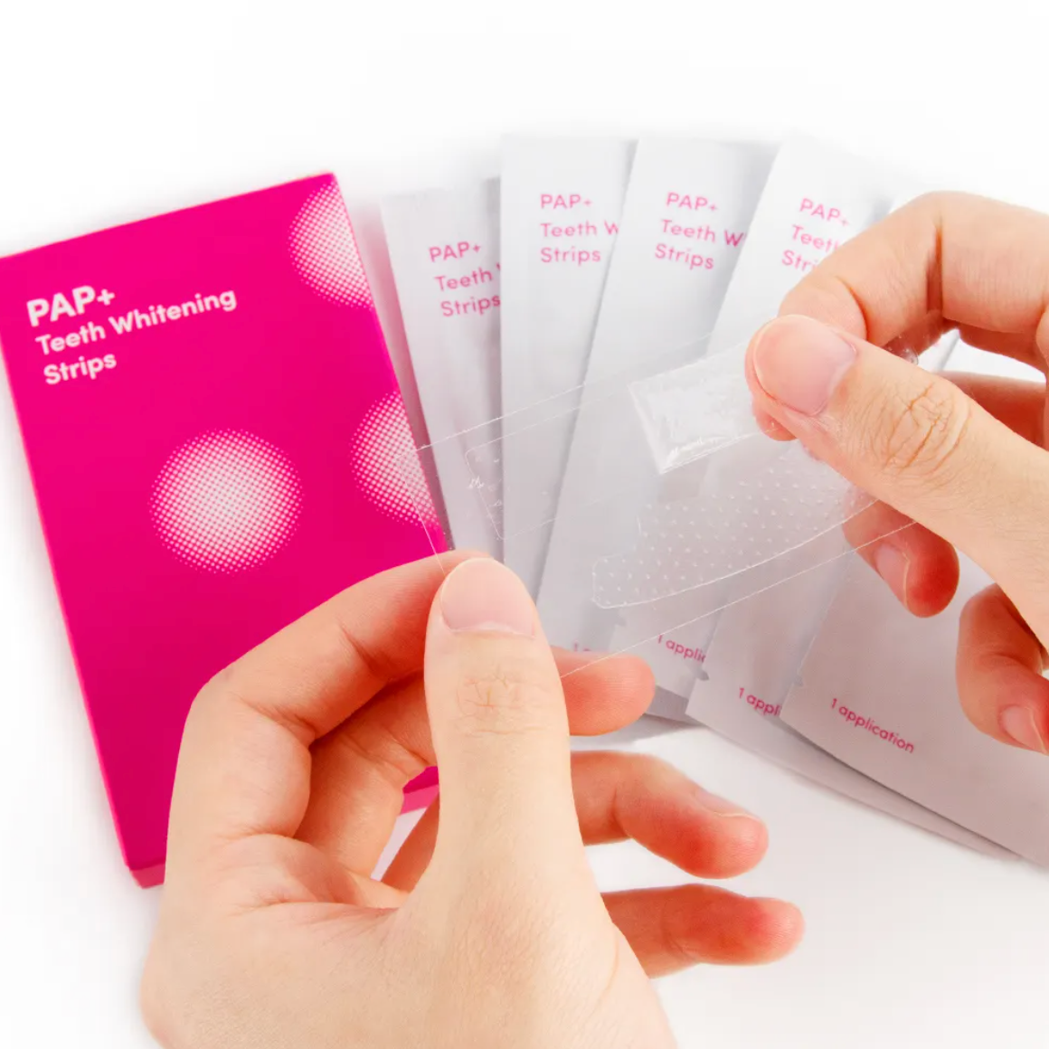Hand peeling pap+ whitening strip from plastic backing.