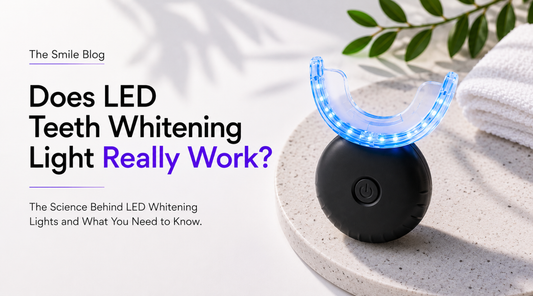 LED teeth whitening light device illuminated with blue LEDs on a stone platform, featured in an educational guide about whether LED teeth whitening lights work.