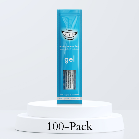 White in Minutes 16% carbamide peroxide professional teeth whitening gel shown as a 100-pack of 10 mL refill syringes in blue retail packaging, made in the USA for professional tray whitening services and high-volume teeth whitening businesses.