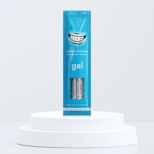 Blue pouch of White in Minutes 22% carbamide peroxide tooth whitening gel on a white platform with a light gray background