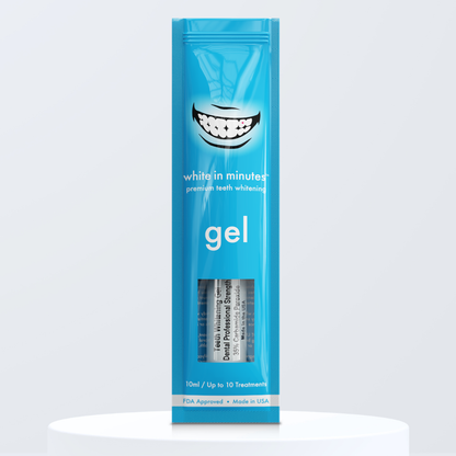 Blue pouch of White in Minutes 35% carbamide peroxide tooth whitening gel on a white platform with a light gray background.