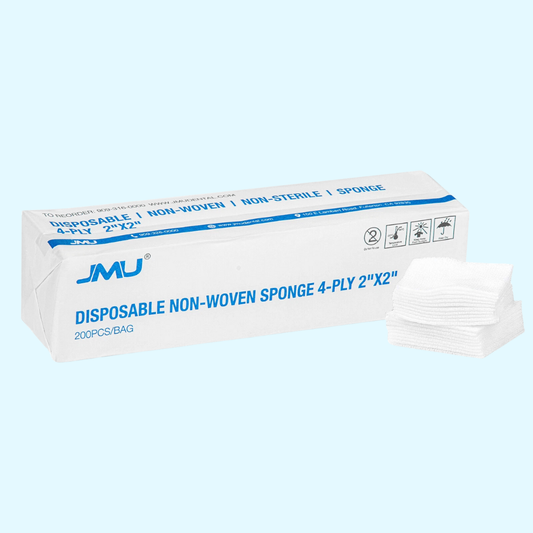 Box of disposable non-woven sponges with JMU branding on a light blue background