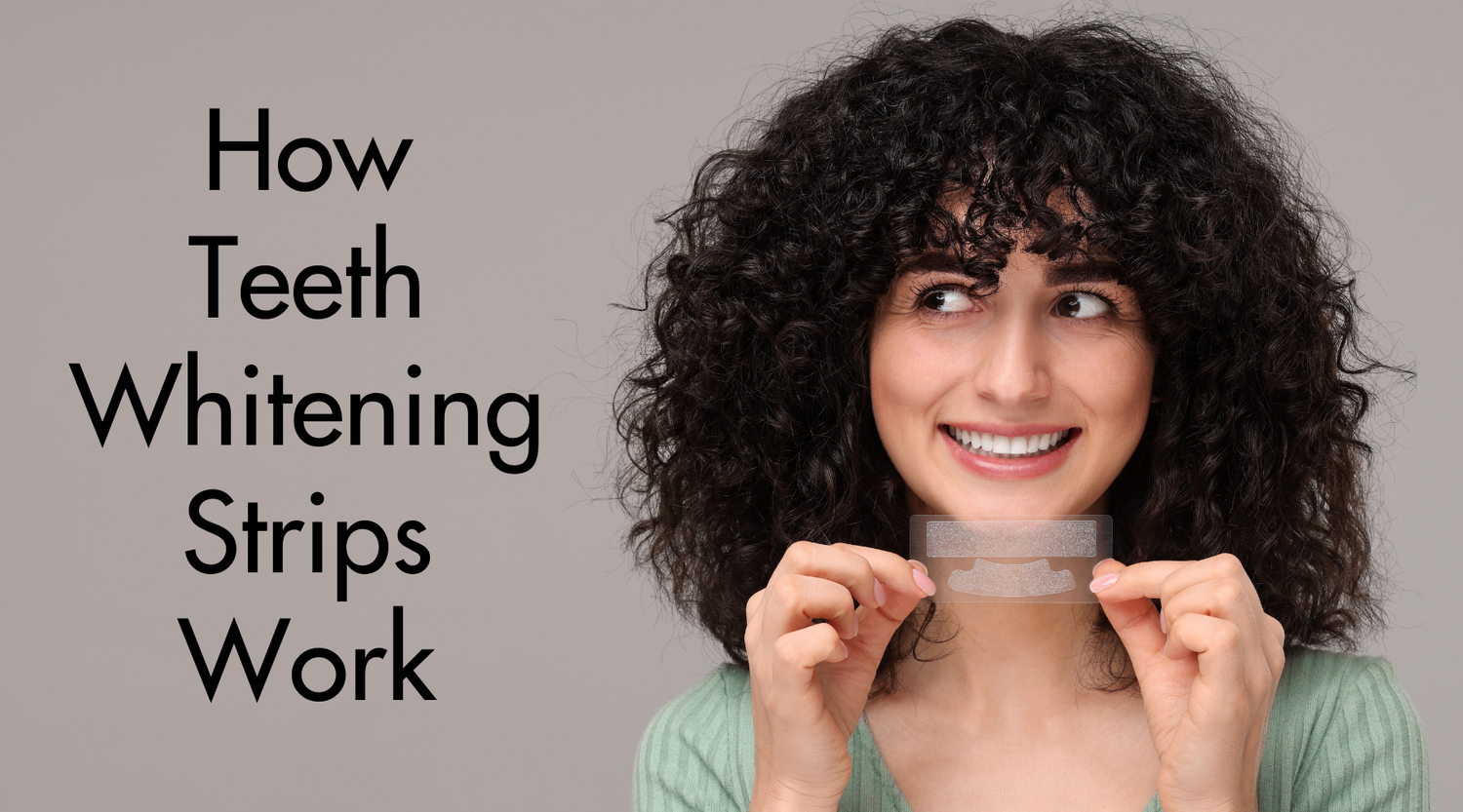 Image of woman with curly hair holding whitening strips on front of her face on grey background with text overlay relating to blog post "How Teeth Whitening Strips Work"