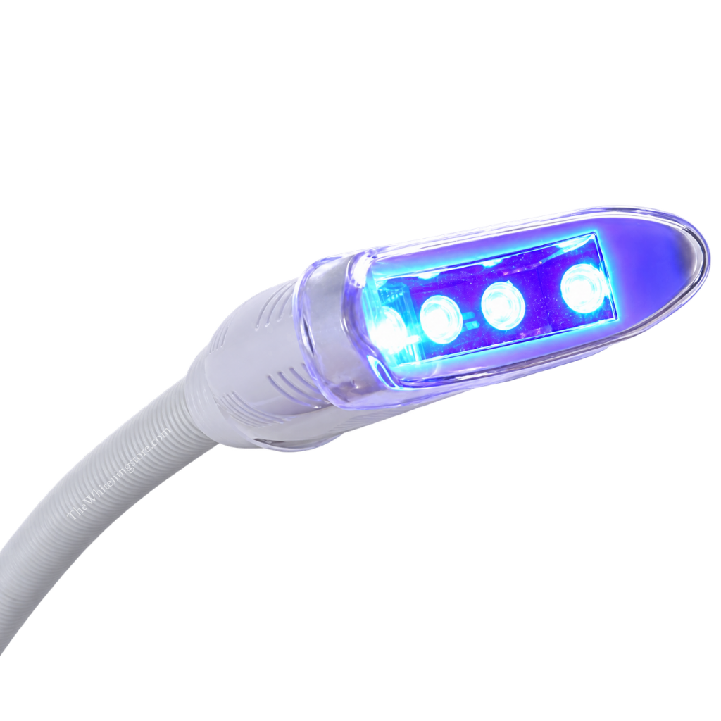 Close-up of Pro20 illuminated professional teeth whitening LED lamp head on a white background, featuring three bright blue LED lights inside a clear curved protective housing, attached to a white vented connector and flexible ribbed gooseneck arm.