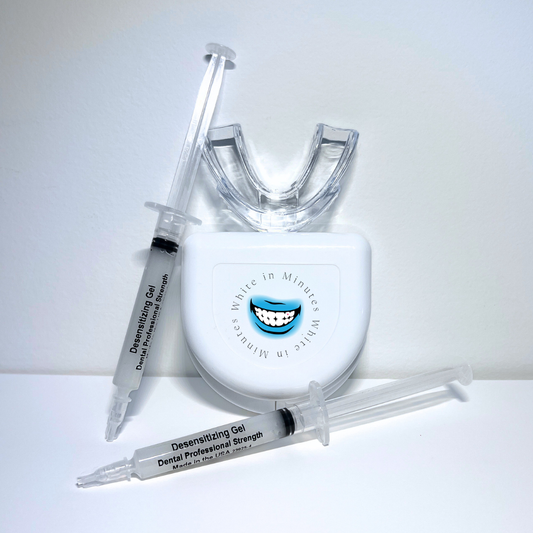 Image of tooth desensitizing kit on white background including two 3ml syringes with desensitizing gel, a clear mouth tray, and a tray case.