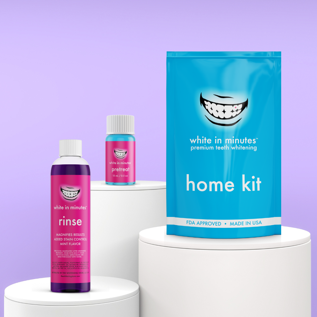 Front-facing display of White in Minutes Everyday Radiance Set on white pedestals with purple backdrop, which includes a home whitening kit, purple mouthwash and stain-lifting pretreat.