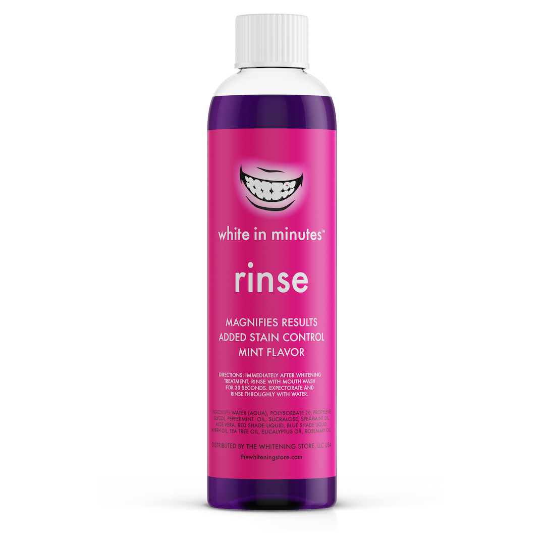White in Minutes Purple Rinse teeth whitening mouth rinse in a tall pink and purple bottle with a white cap, labeled mint flavor and added stain control, shown on a white background.