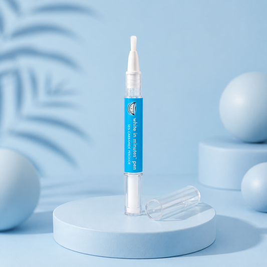 White in Minutes 16% Carbamide Peroxide teeth whitening pen with brush applicator and clear cap displayed on a pale blue luxury studio pedestal with soft modern styling and high-end skincare-inspired lighting.