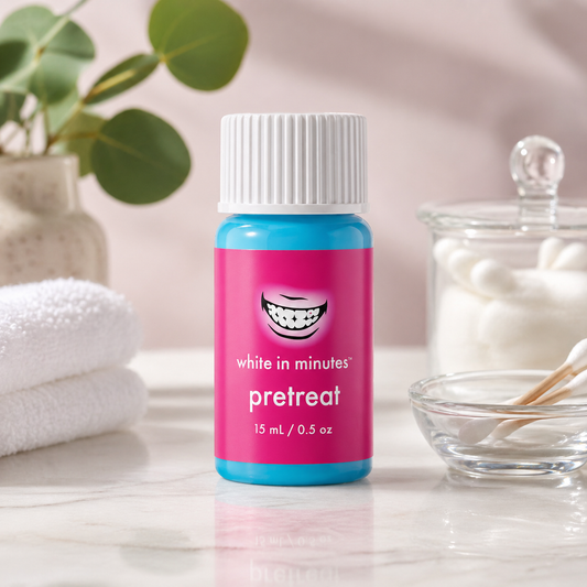 White in Minutes PreTreat teeth whitening booster bottle on a clean spa-style counter with cotton swabs and soft neutral background.