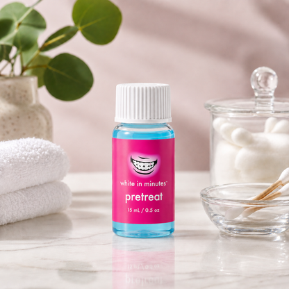 White in Minutes PreTreat teeth whitening booster bottle on a clean spa-style counter with cotton swabs and soft neutral background.