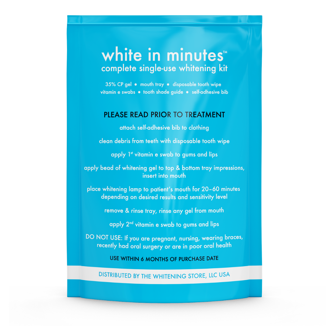Back of a bright blue White in Minutes Complete Single-Use Whitening Kit pouch showing the kit contents, including 35% carbamide peroxide gel, mouth tray, disposable tooth wipe, vitamin E swabs, tooth shade guide, and self-adhesive bib. The package also displays step-by-step professional teeth whitening treatment instructions, a 20 to 60 minute whitening lamp guideline, safety warnings, and The Whitening Store distributor information.